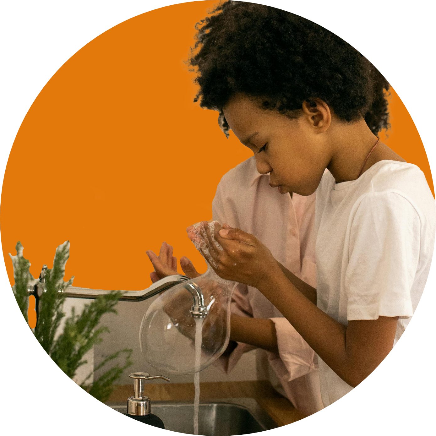 Child washing hands carefully over a sink