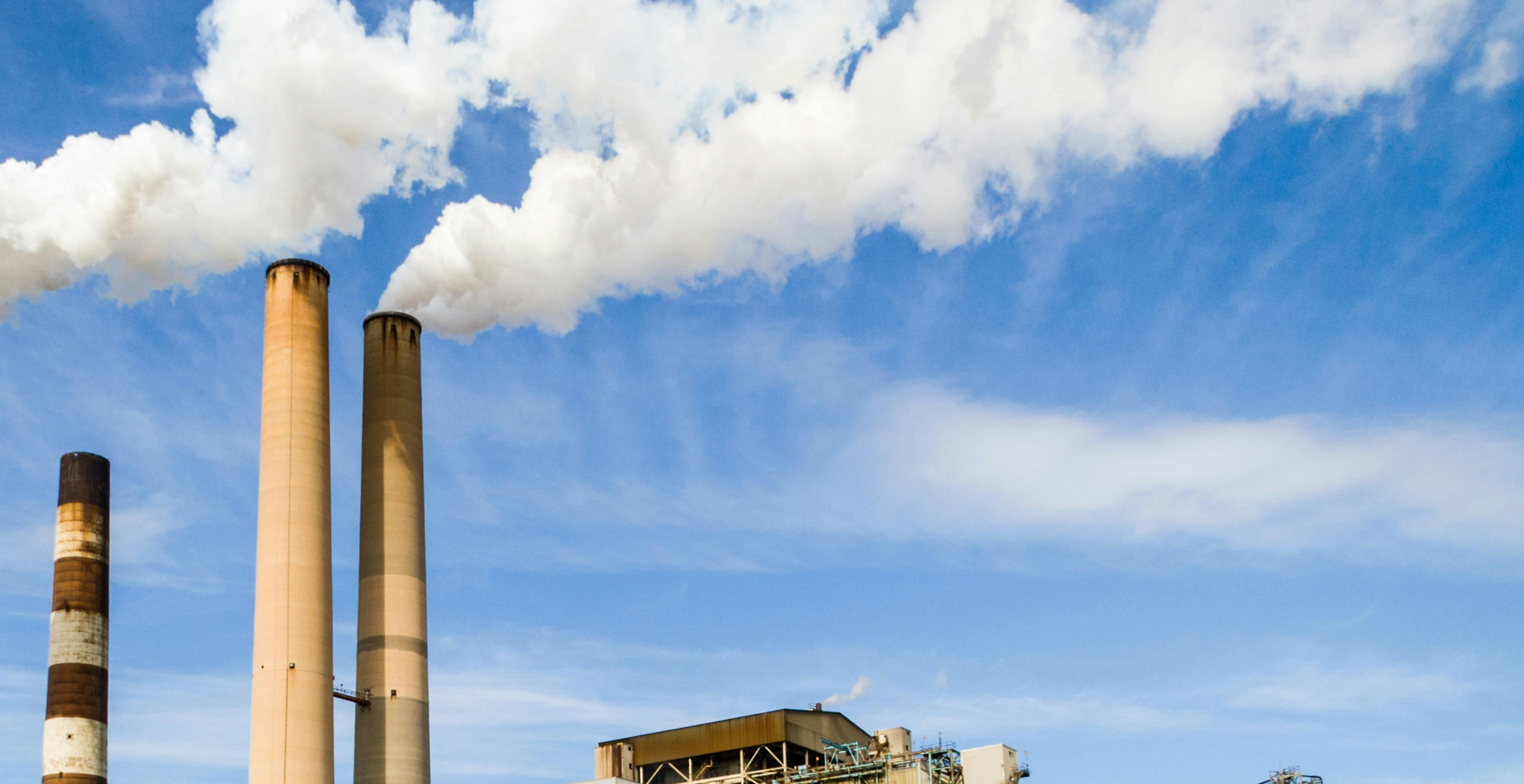 Industrial smokestacks emitting smoke
