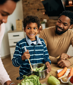 Black family cooking healthy food together