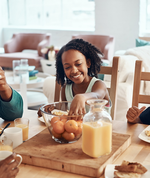 Black family eating together at home with love and connection